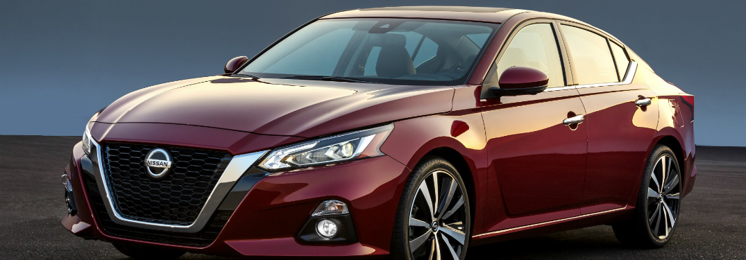 red 2019 nissan altima against black and blue background