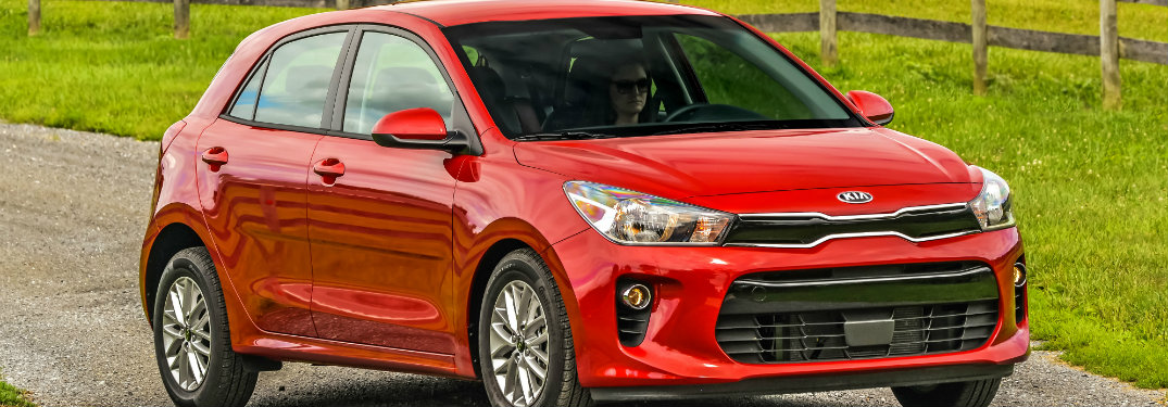red kia rio on country road