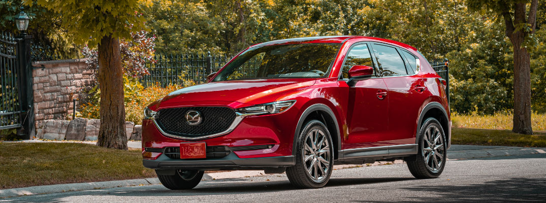 A front left quarter photo of the 2020 Mazda CX-5 parked on the street.