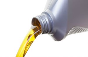 isolated image of oil being poured out of bottle