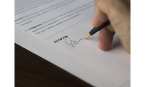 Hand signing some papers