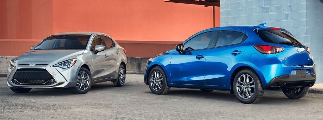 Exterior view of a silver 2020 Toyota Yaris and a blue 2020 Toyota Yaris