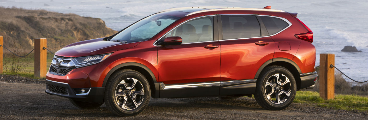 Exterior view of a red 2018 Honda CR-V parked with an ocean in the background