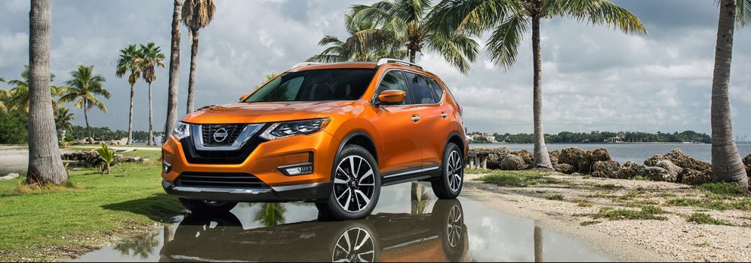 Orange 2018 Nissan Rogue parked by a beach