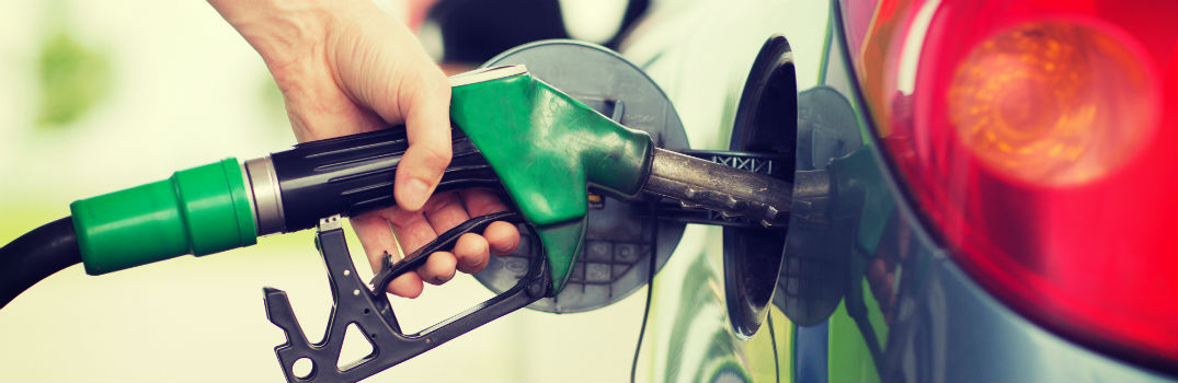 person filling up a vehicle with fuel