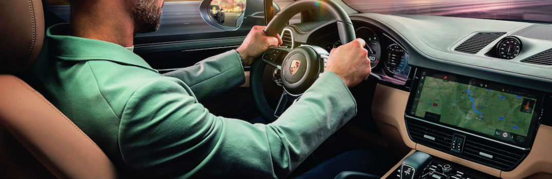 man driving a Porsche car