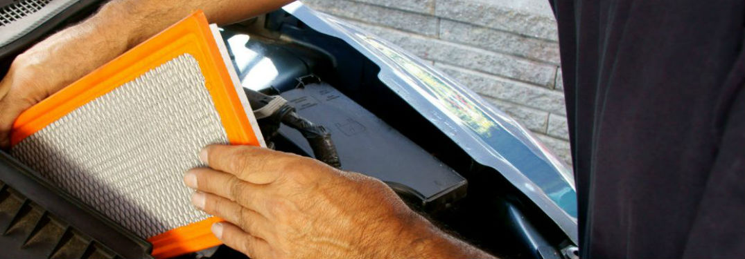 person changing cabin air filter