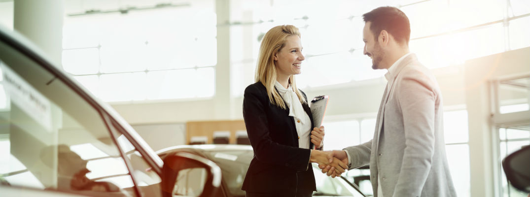 A stock photo of a sales person helping a customer.