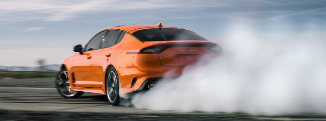 A photo of the 2020 Kia Stinger GTS doing a burnout.