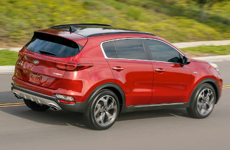 2020 Kia Sportage exterior back fascia passenger side on road with grass and sidewalk