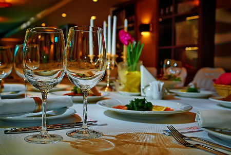 Wine glasses on table set for a romantic dinner