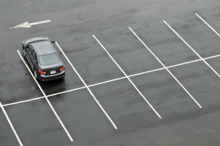 Car in empty parking lot