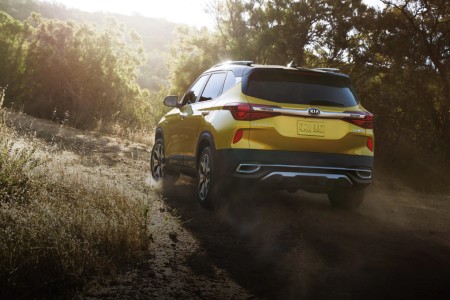 2021 Kia Seltos exterior rear fascia driver side offroad with trees and sunlight