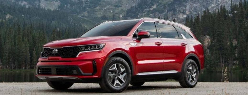 Red colored 2021 Kia Sorento Hybrid with mountains at the back
