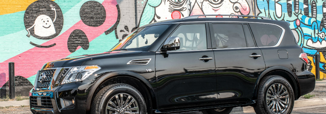 2019 Nissan Armada Pricing and Mileage Info with image of Armada parked by wall with graffiti