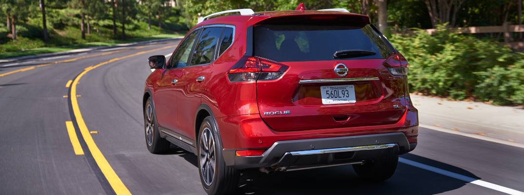 Rear view of red 2020 Nissan Rogue on the road
