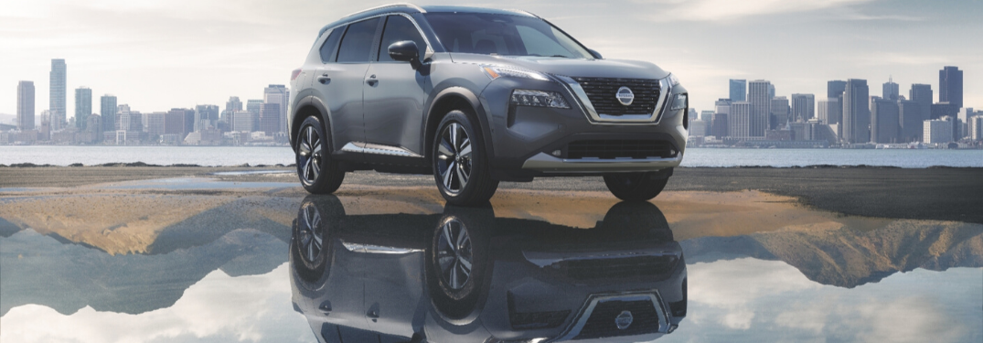 Gray 2021 Nissan Rogue Next to Water with City Skyline in the Background