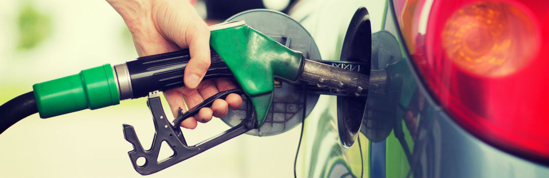 person filling up a vehicle with fuel