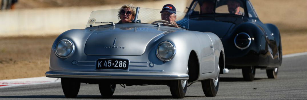 Wolfgang Porsche driving a porsche at a large event