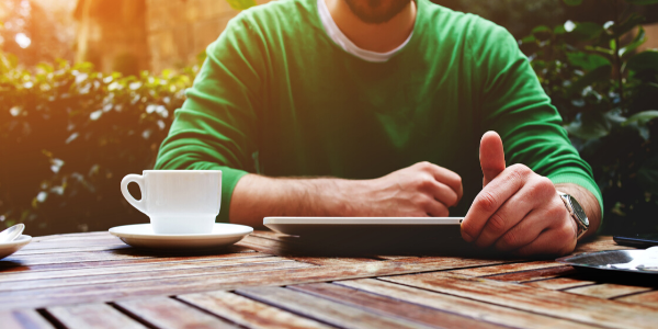 Man sitting at table with tablet