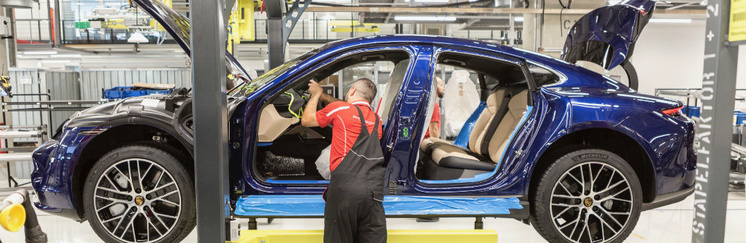 man working on production of Porsche Taycan in Porsche factory