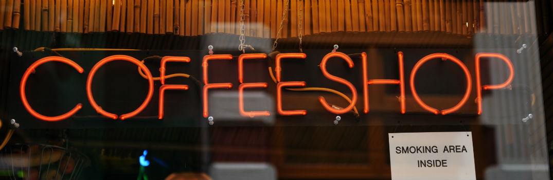 neon coffee shop sign on glass window