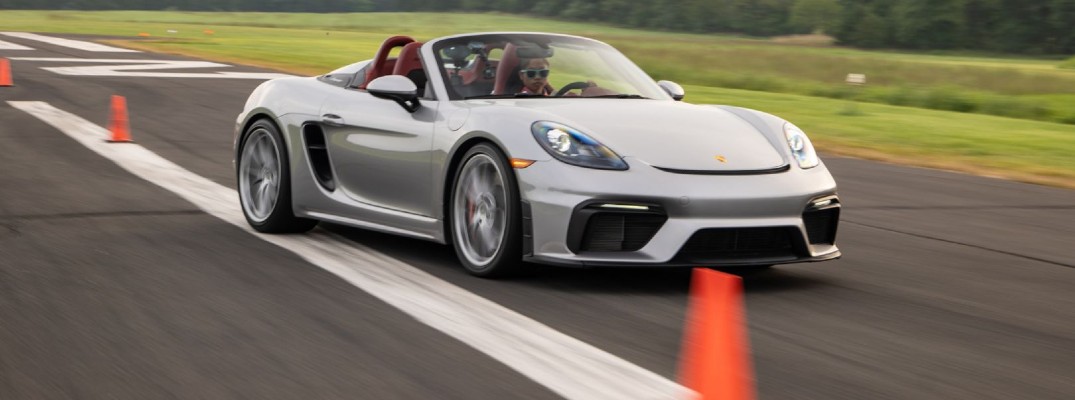 A photo of Chloe Chambers behind the wheel of a 2020 Porsche 718 Spyder while setting a world record.