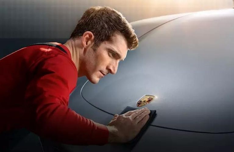 Porsche professional cleaning the car bonnet