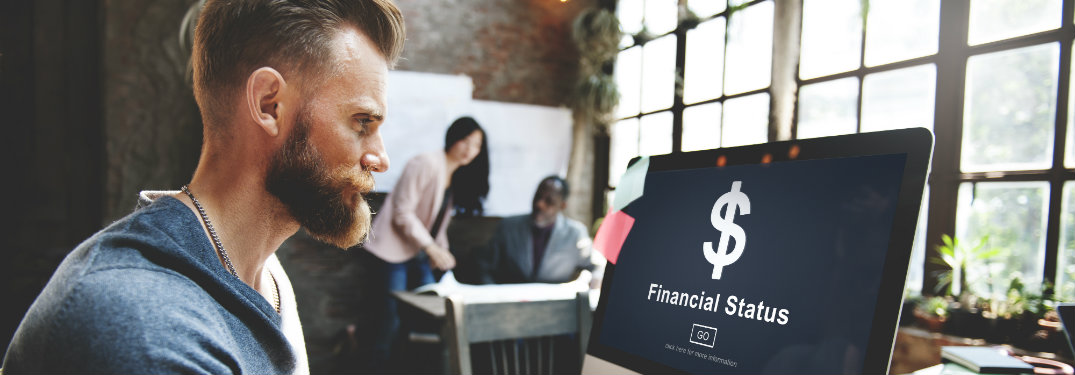 Man Looking at Computer Screen with Financial Status