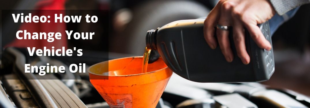 Hand pouring engine oil into engine with Video How To Change Your Engine Oil text to left