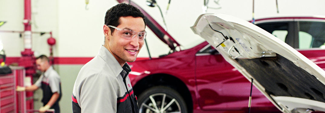 mechanic in front of car
