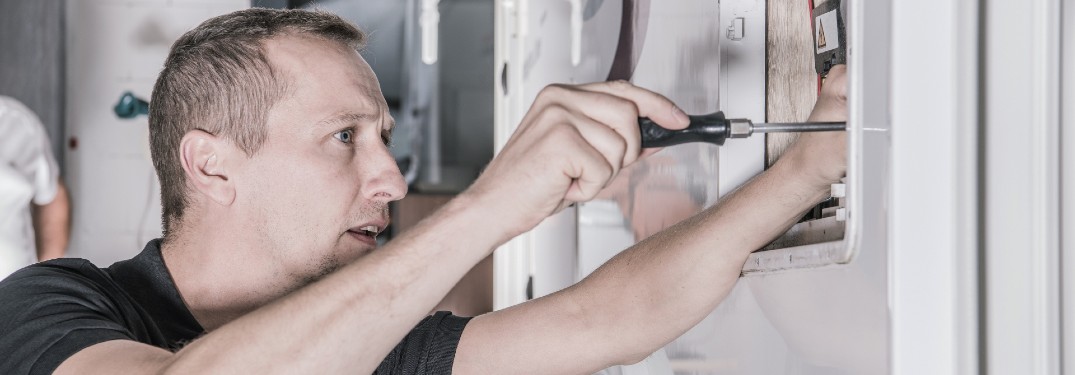 Man working on fixing an RV