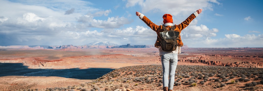 Hiker with arms up in Arizona desert