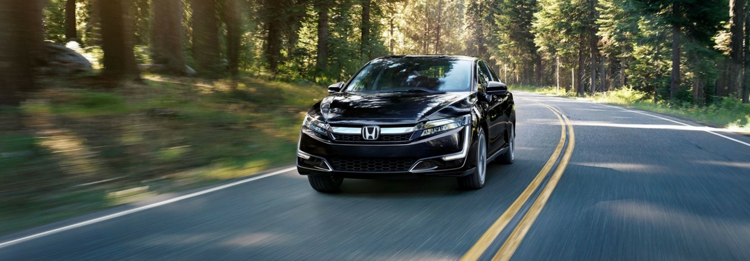 2018 honda clarity plug-in hybrid driving through a forest
