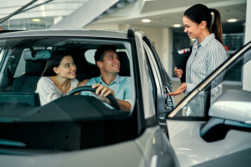 Couple at car dealership