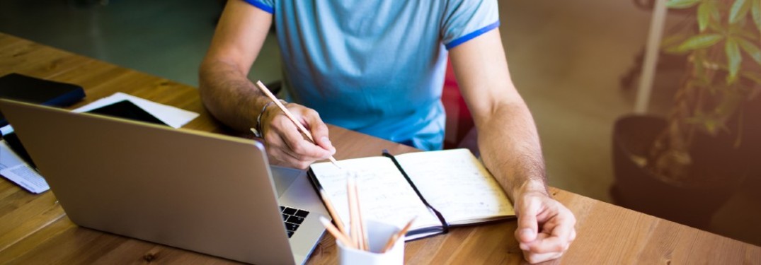 college grad studying at a table