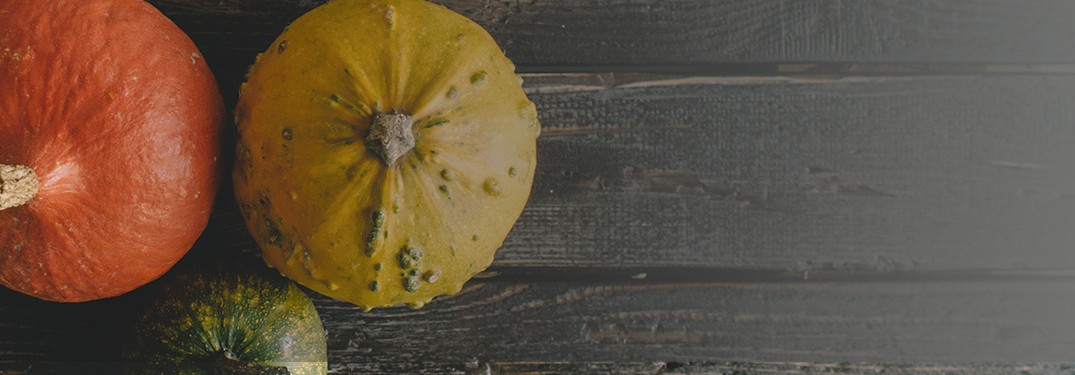 three pumpkins on wood