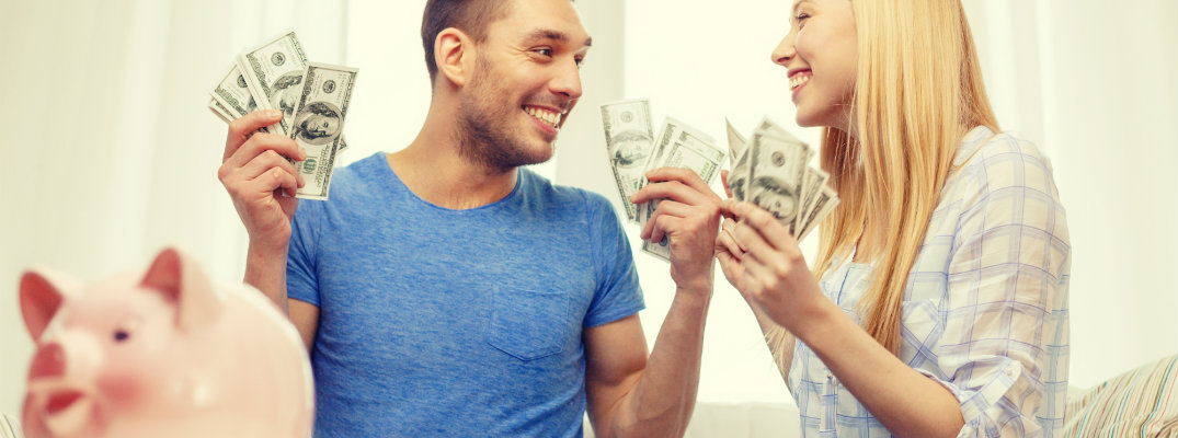 Couple holding a large sum of cash
