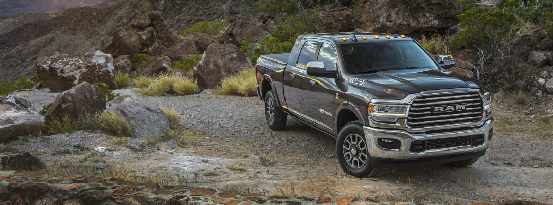2019 Ram 2500 Heavy Duty exterior shot parked at a grassy rocky cliff as the sun sets in the sky