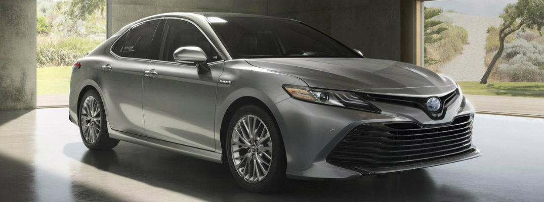 Profile shot of gray 2018 Toyota Camry parked in building with pillars surrounding