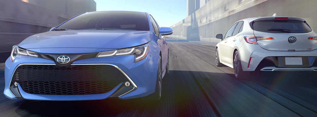 Two 2019 Toyota Corolla Hatchback models driving on city road