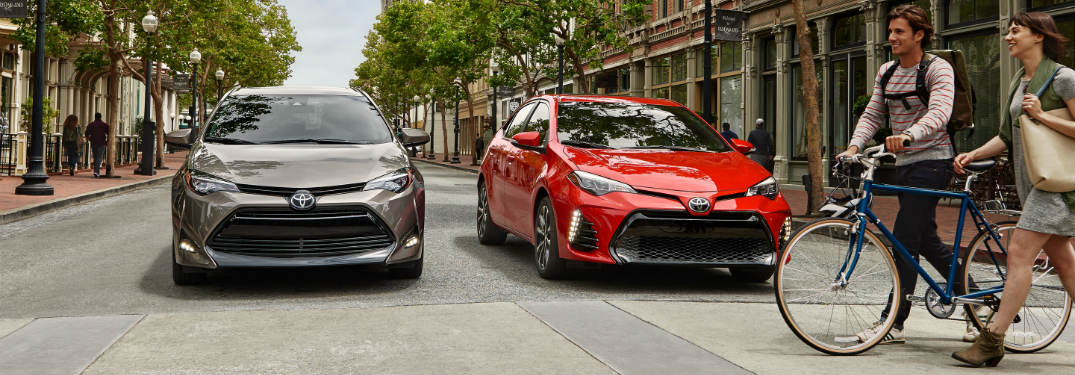 Two 2018 Toyota Corollas stopping for a biker