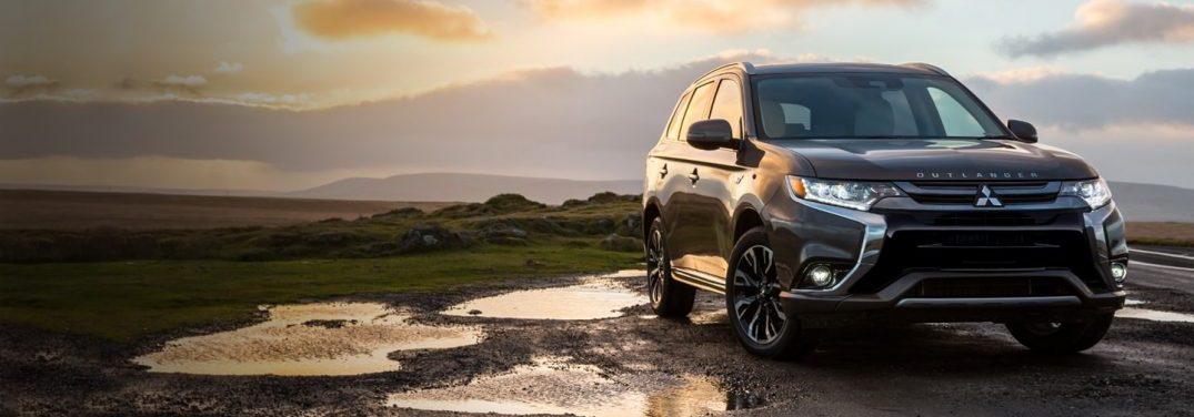 2018 Mitsubishi Outlander PHEV parked by a sunset