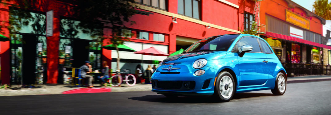 Blue 2018 Fiat 500 driving down the street