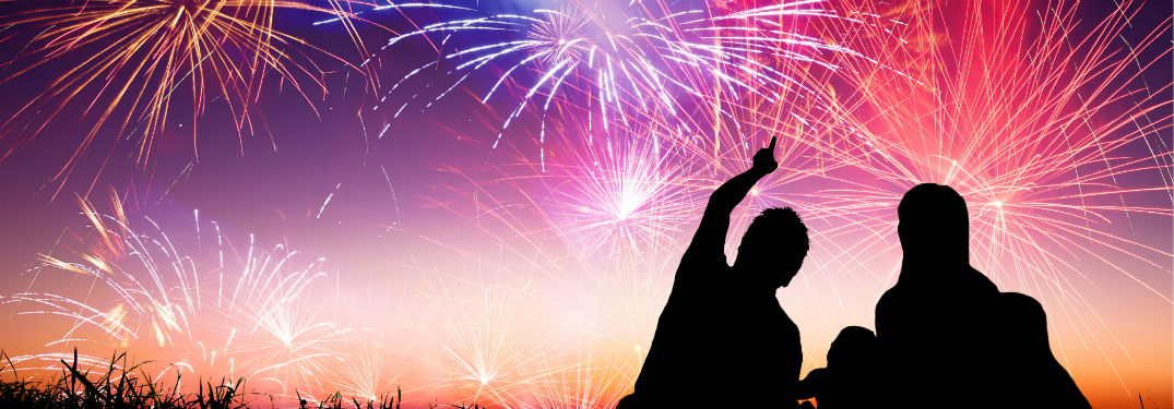 family watching fireworks at night
