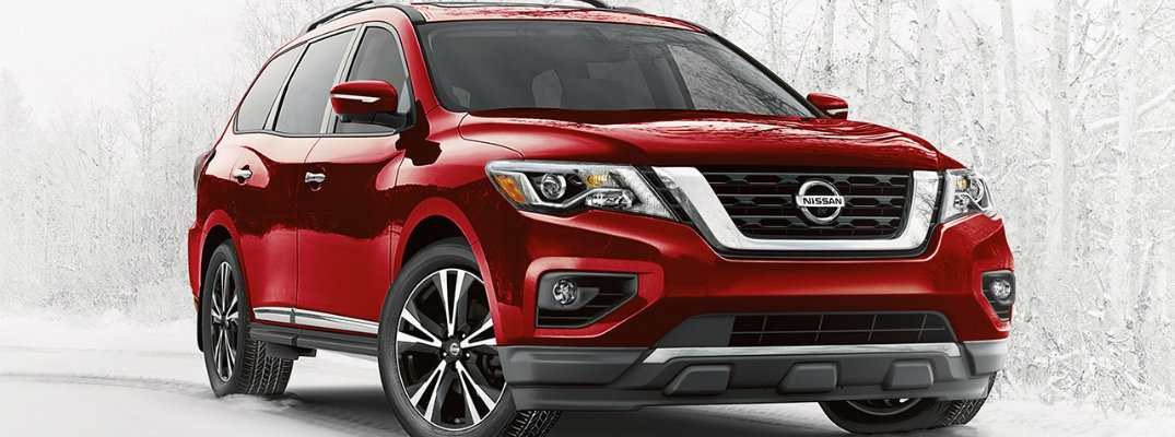 2018 nissan pathfinder red parked in stark white snowy forest