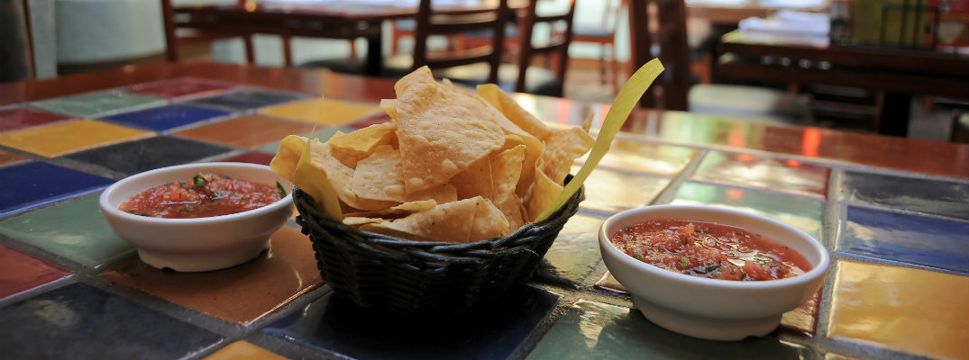 tortilla chips and salsa on a table in a mexican restaurant for cinco de mayo celebrations