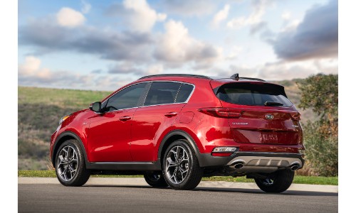 2020 Kia Sportage SUV redesign exterior rear shot showing back bumper and taillight design while parked under a cloudy blue sky