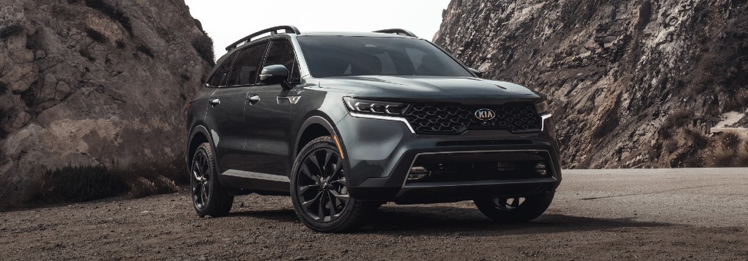 2021 Kia Sorento exterior shot with Gravity Gray paint color parked on a gravel plain surrounded by rocky cliffs