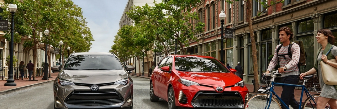 2018 Toyota Corolla parked outside with people walking.